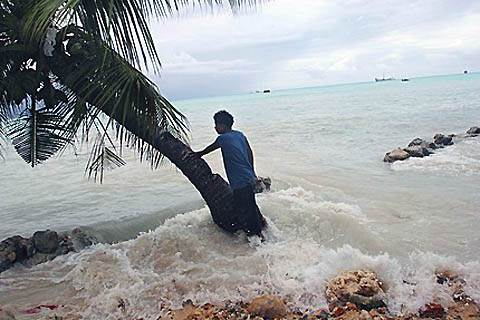 Pita Meanke of Betio village watches the water crash through the sea wall his family built on the South Pacific island of Kiribati.
courtesy of islandbreath.org
courtesy of islandbreath.org