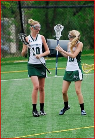 Seniors Devon Hoffman and Allie Kenny give each other a pep talk to get through a varsity lacrosse game as freshmen. 