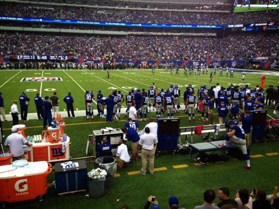 The New York Giants prepare for their football game aganist the Philadelphia Eagles. The athletic trainor is talking to quarterback Eli Manning.
Maddie Caponiti 15