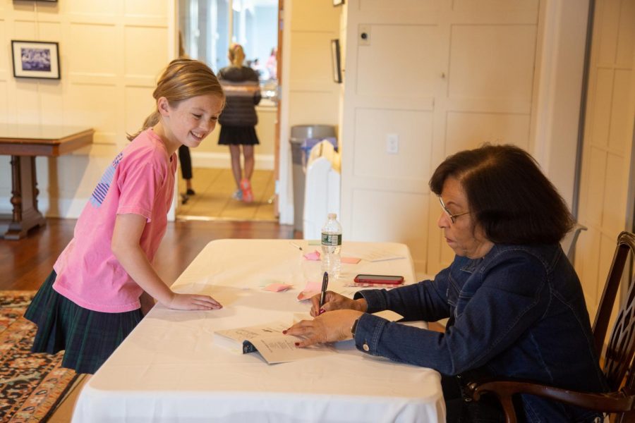Ms. Sharon Draper signs one of her books during her visit to Sacred Heart Greenwich. Courtesy of Ms. Rachel Zurheide 