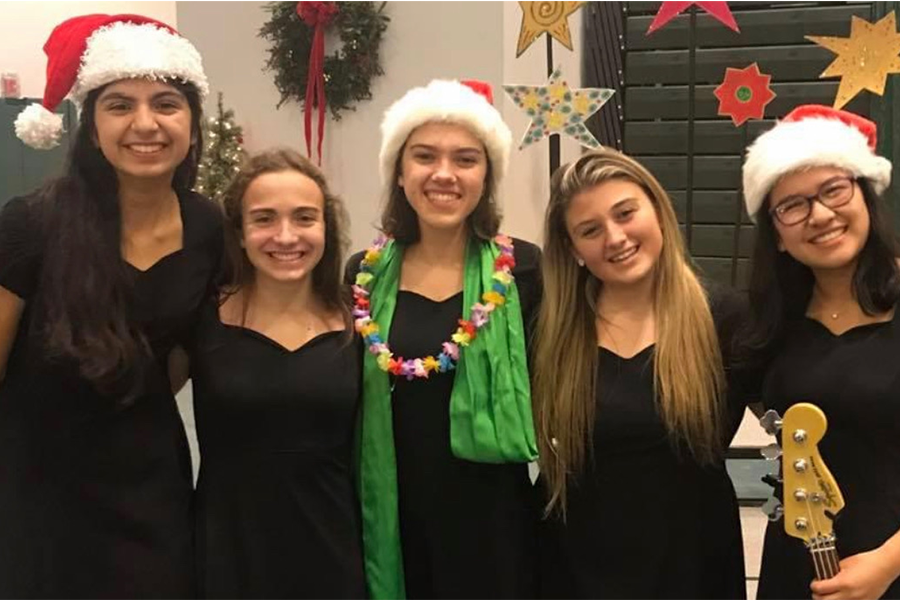 Madison Mezzatesta 21, along with alumnae Malika Amoruso 20, Elisa Howard 20, Kara Hodge 20, and Sydney Kim 20, perform in the 2019 Christmas Concert.